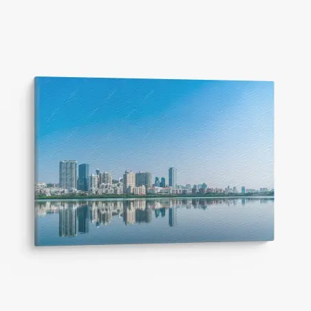 Leinwandbild ruhige stadtsilhouette mit spiegelung im wasser – Wallnifity®